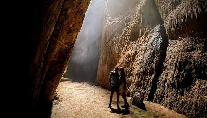 Couple embracing in a cave.